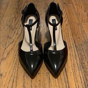 Black patent leather T-strap pumps